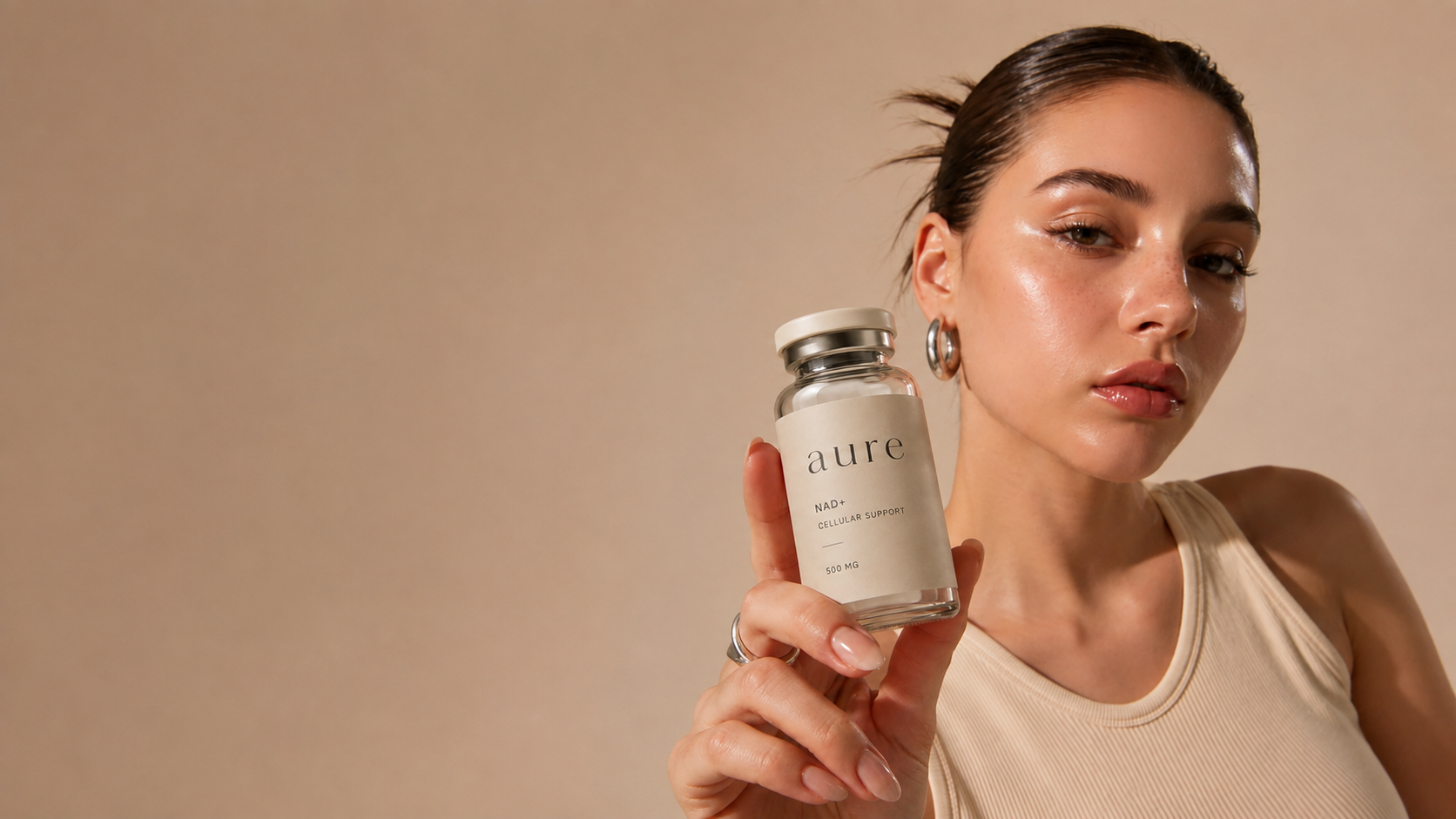 Woman holding an Aure NAD+ cellular support vial